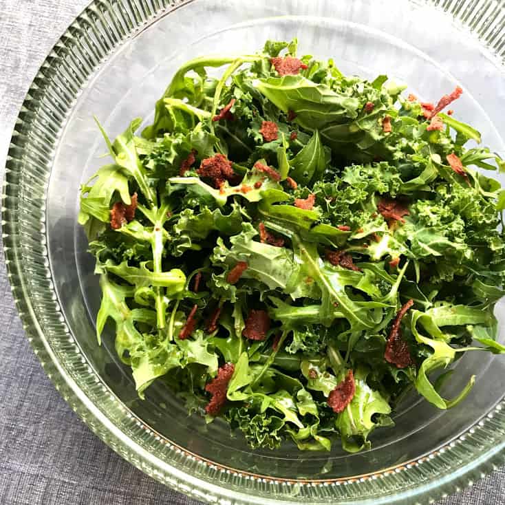 kale and arugula in a clear bowl