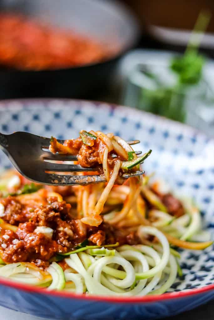 Beef Bolognese Recipe - Savory Thoughts. Sauce and noodles wrapped around fork.