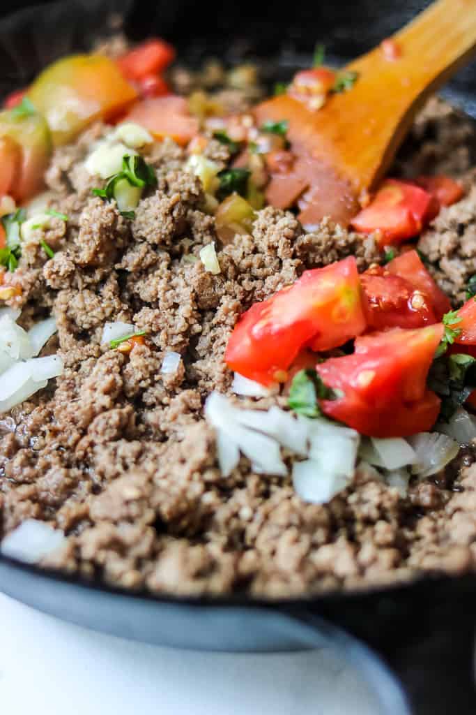 Beef Bolognese Recipe - Savor Thoughts Beef Bolognese Recipe - Savor Thoughts. Tomatoes, garlic, herbs, and onions being added to the beef.