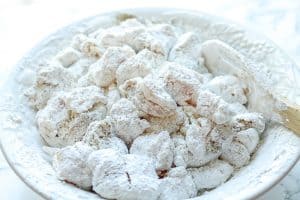 Cashew Chicken Recipe - Preparing Chicken for Cooking in a White Plate with a Wooden Spoon