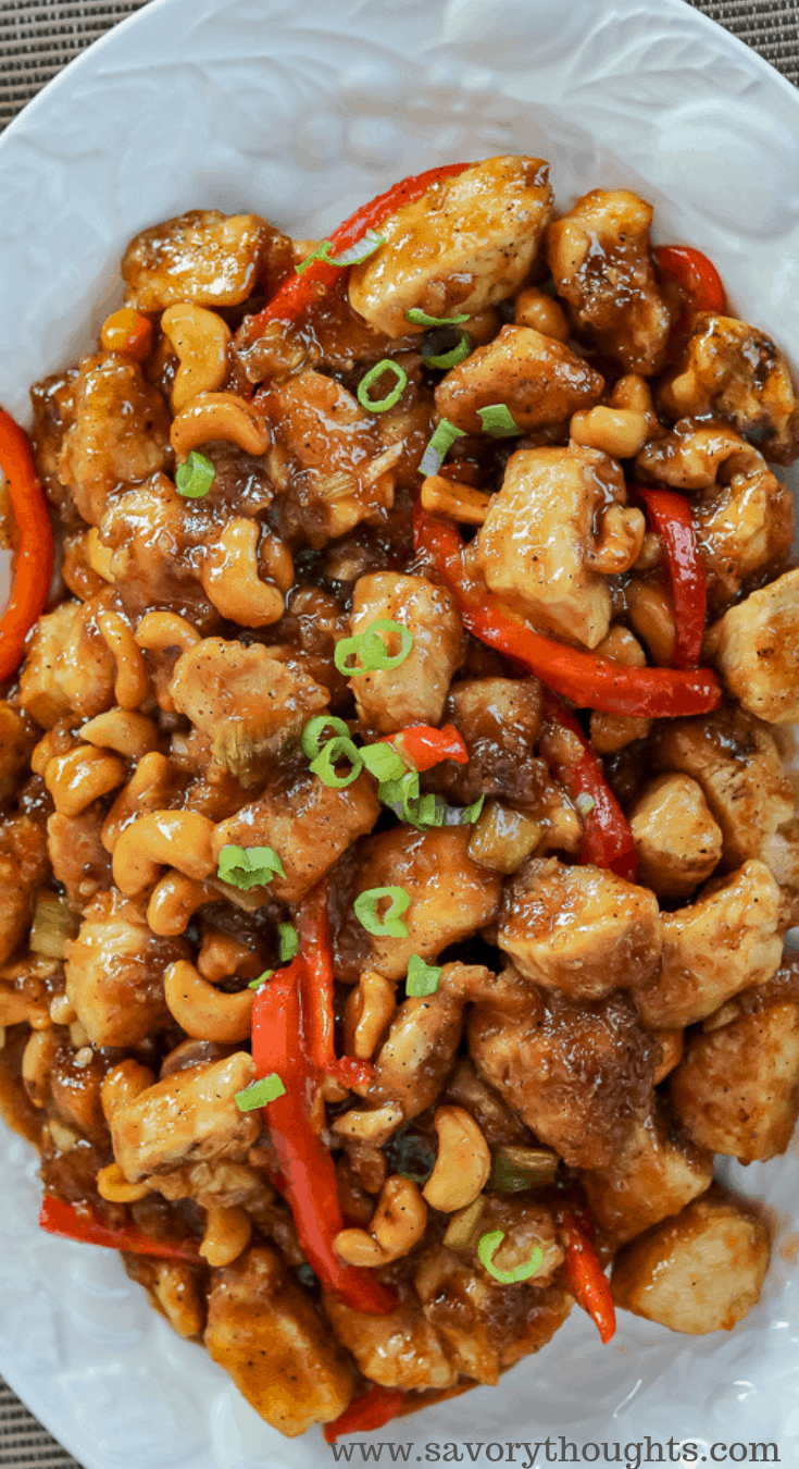 Cashew Chicken Recipe - Vertical Shot of the Cooked Recipe in a White Plate Served and Ready for Dinner
