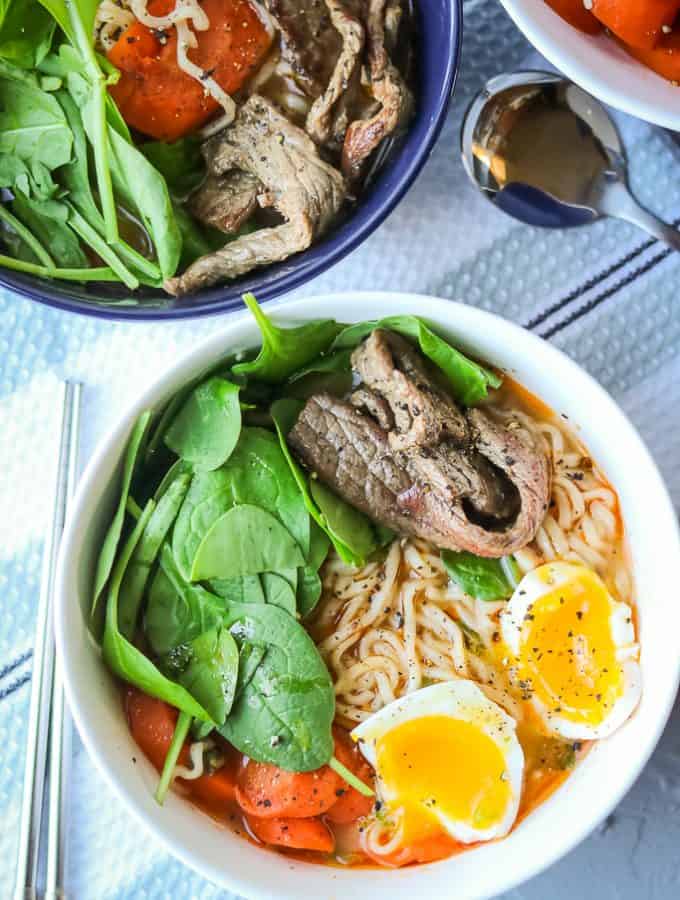 Spicy Beef Ramen Noodles. Easy beef soup recipe made with ramen noodles. Healthy and spicy. Soup made with eggs added and topped with spinach and carrots. Homemade, Authentic, and delicious. Easy and cheap to make. Best Spicy Ramen Noodle Soup. Full recipe at www.savorythoughts.com