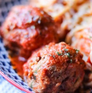 Delicious slow cooker meatballs that are cooked for 3 hours and saturate with red wine, tomato sauce, garlic, and herbs.