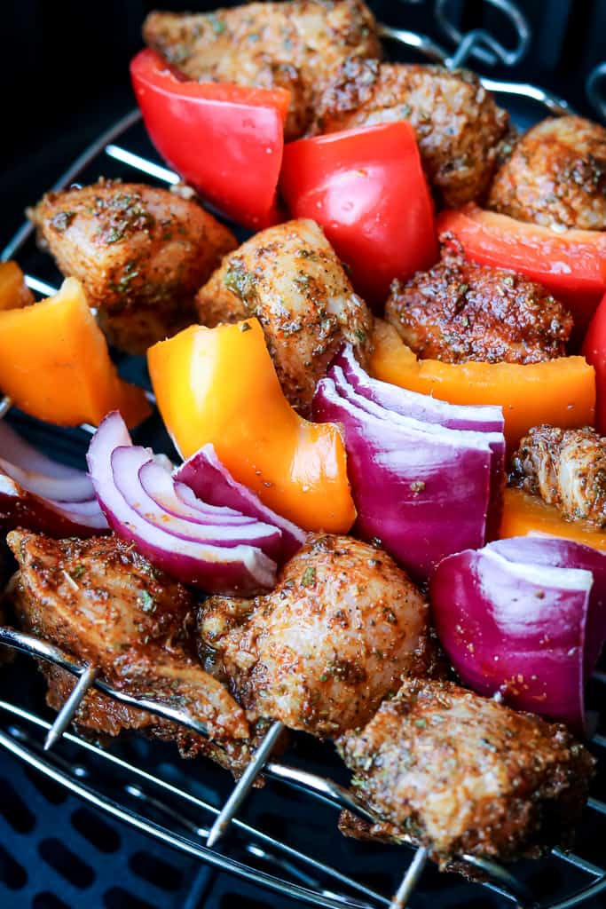 Air Fryer Grilled Chicken Skewers threaded in a pattern to be place in the air fryer basket.