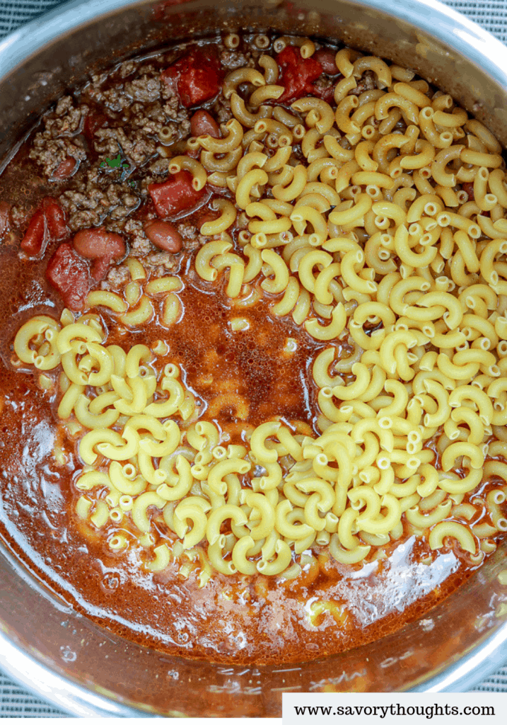 This Instant Pot Chili Mac And Cheese is totally ON POINT! Combine two of your favorite comfort foods in ONE POT to create the ultimate cheesy ONE POT MEAL. It is a hearty, quick, delicious, and comforting recipe for chili mac and cheese. Perfect for busy nights, one pot wonder chili mac and cheese recipe. This tasty chili mac and cheese is perfect for a family meal.