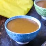 Haitian Labouyi in a blue bowl and in a green bowl with yellow paper in the background.