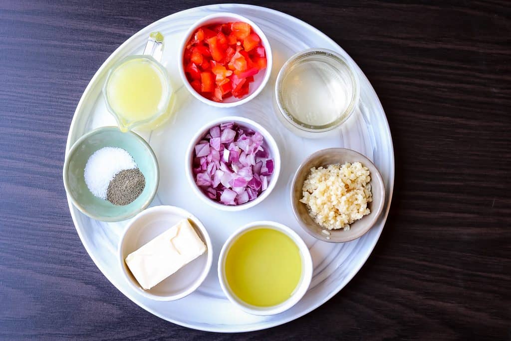 Ingredients to make shrimp linguine on a white plate