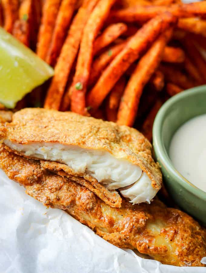 Crispy, juicy, tender air fryer tilapia cooked to perfection to create the best air fryer fish and chips recipe. These Air Fryer Fish and Chips are exactly what you need to put on the menu every week! Air Fryer recipes are an excellent way to enjoy healthy, crispy foods. The air fryer tilapia is cooked to perfection without using a large amount of oil. #airfryerfishandchips #glutenfreefish #bestfishandchips #Airfryerfishandchipsrecipes