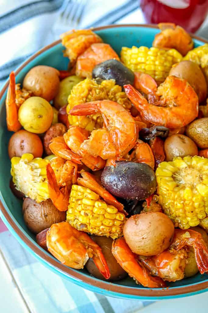 Low Country Shrimp Boil Pot Recipe – there’s nothing better to enjoy in the summer like good shrimp boil recipe. This Instant Pot low country boil recipe has summer and deliciousness written all over it! Definitely feeds a crowd. It is finger-licking-good and is filled with seafood flavor/seasoning from the old bay seasoning. #shrimpboilpot #lowcountryshrimpboil #seafoodboilpot #shrimpboilrecipe #lowcountryshrimpboil #oldbayseasoning #shrimpboilspices