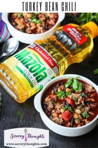 Two bowls of chili with Mazola Corn oil in the middle. Turkey Bean Chili written on top.