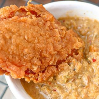 crispy wing dipped in Haitian sauce