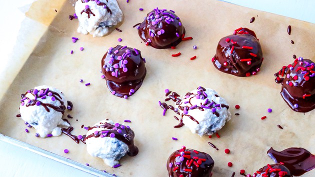 Chocolate sprinkled covered Oreo cream cheese balls on line cookie sheet