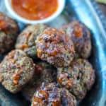 Air fryer meatballs in silver platter with homemade tomato paste sauce