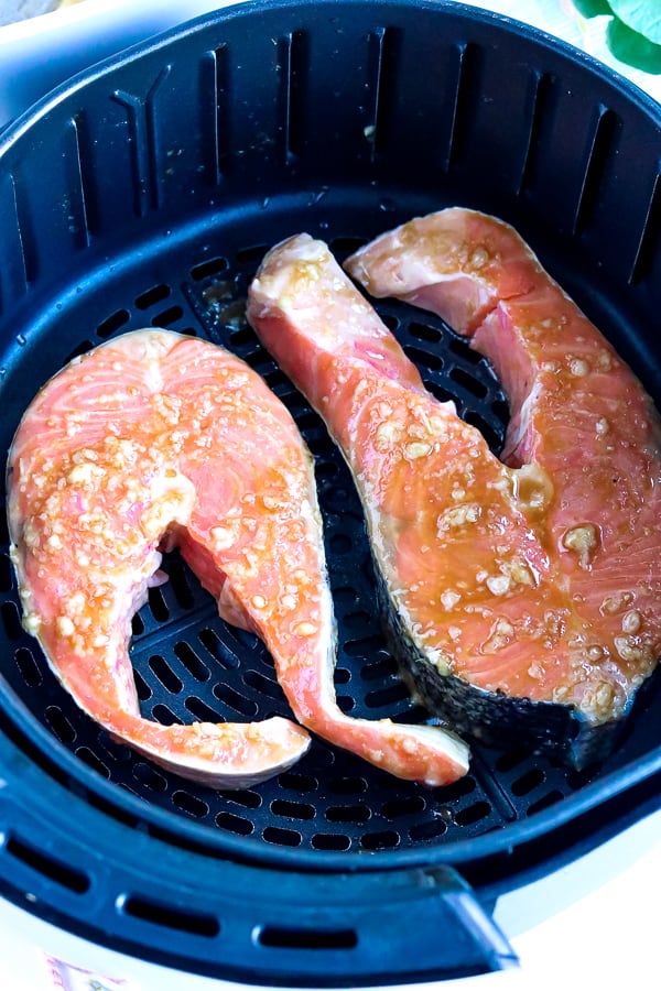 marinaded salmon steaks in air fryer basket