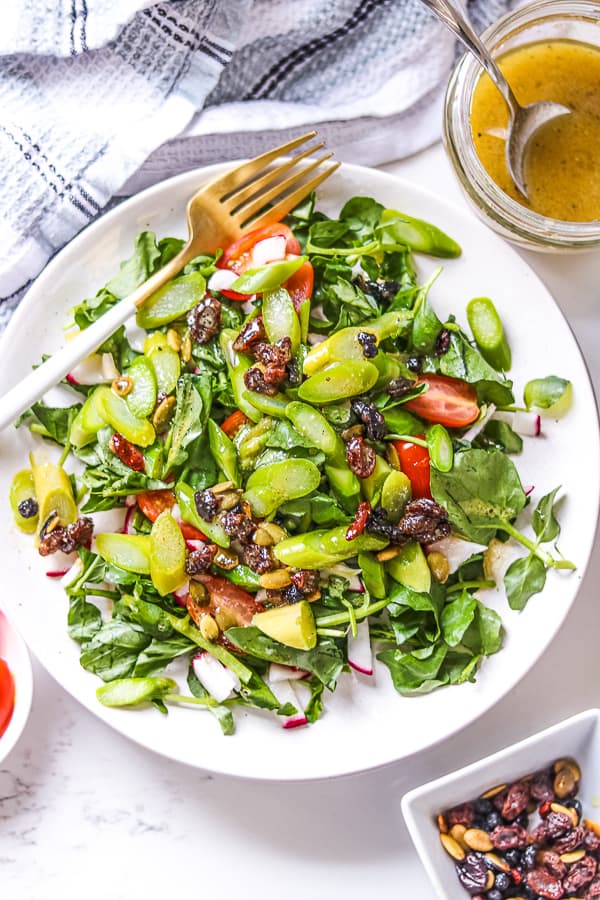 Asparagus salad with cranberry vinaigrette  on white plate