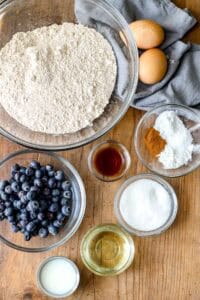 ingredients displayed on wooden board to make whole wheat muffins