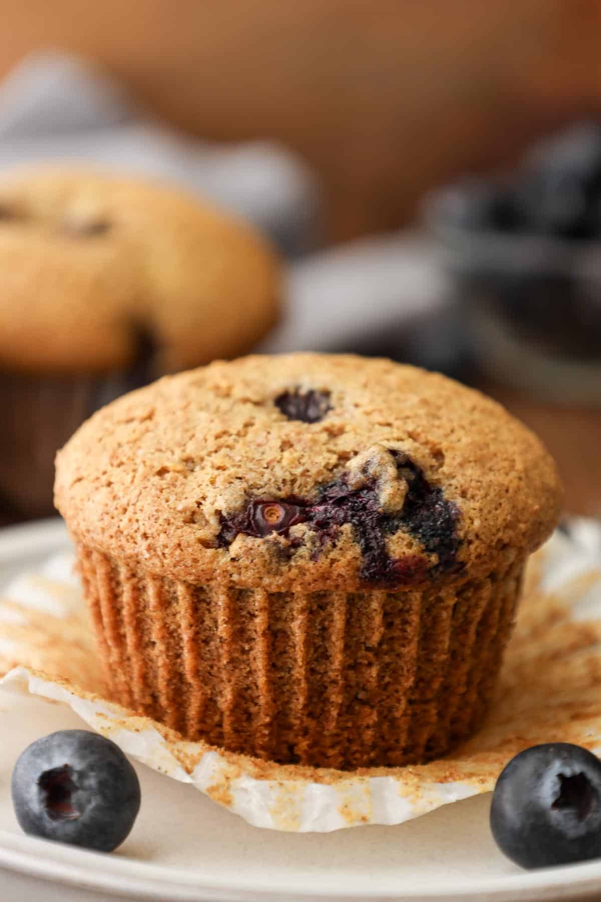 blueberry muffins with fresh berries on the side