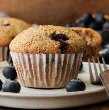 blueberry muffins with fresh berries on the side