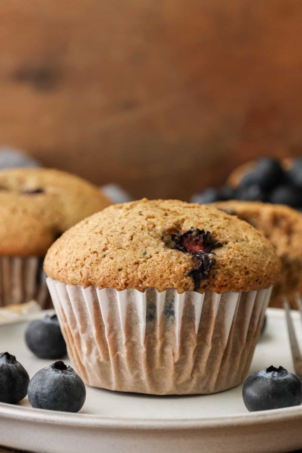 blueberry muffins with fresh berries on the side