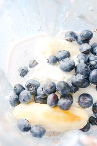 Blueberries, banana, ice cream, milk in blender