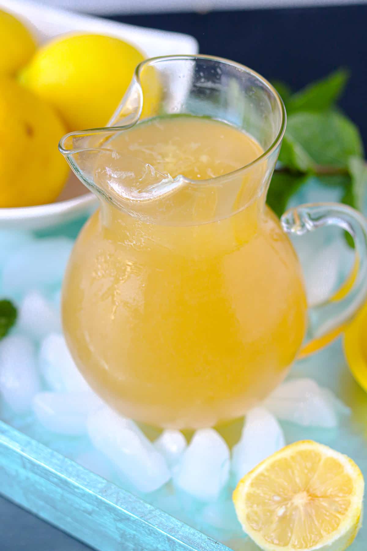 Haitian Lemonade in pitcher on top of tray with glass