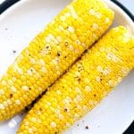 two corn on white plate