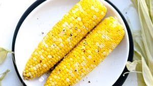 two corn on white plate