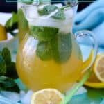Jus Citron in glass pitcher filled with mint on ice