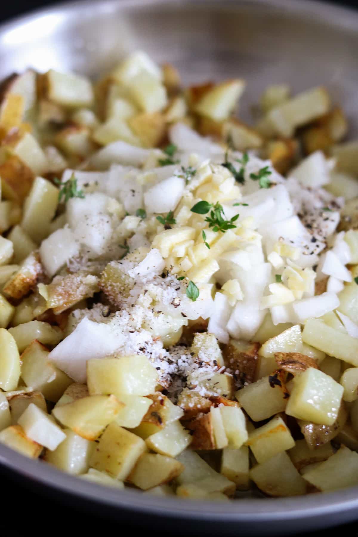 potatoes topped with seasoning and onions