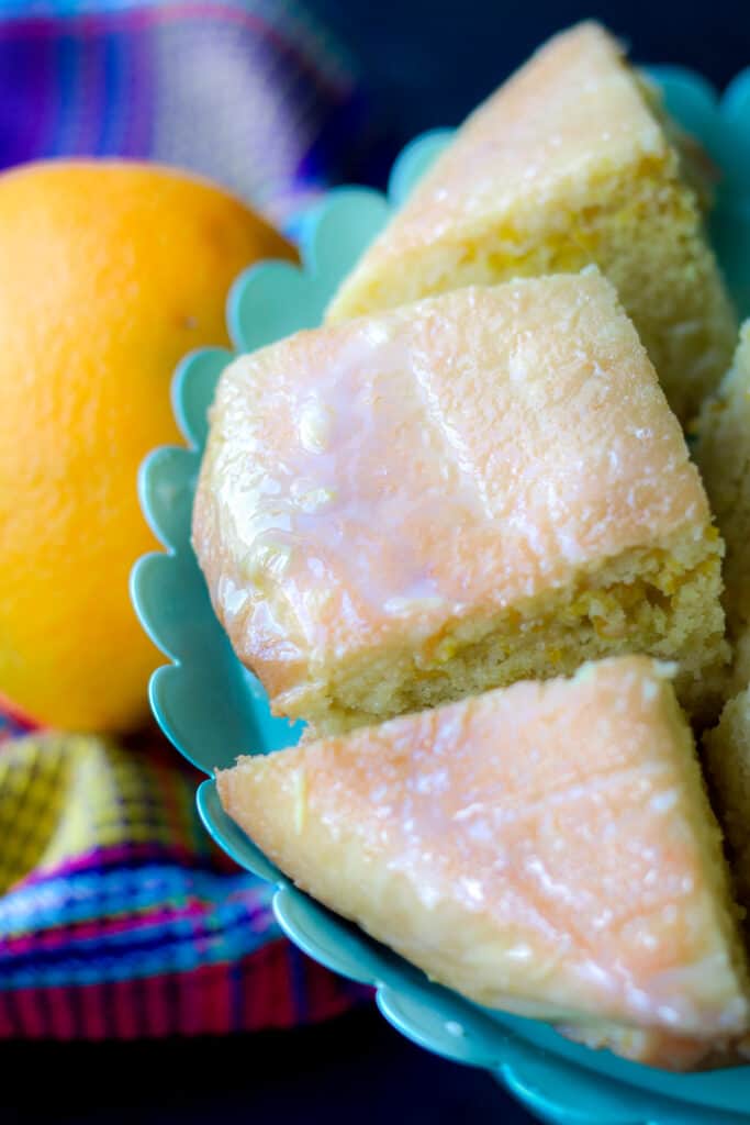 Orange Cake squares on green cake pan