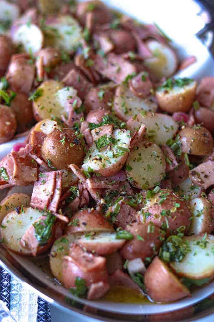 Potato Salad topped with bacon and fresh parsley