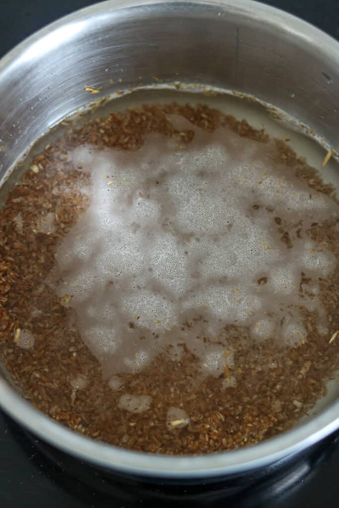 Bulgur covered in water in saucepan