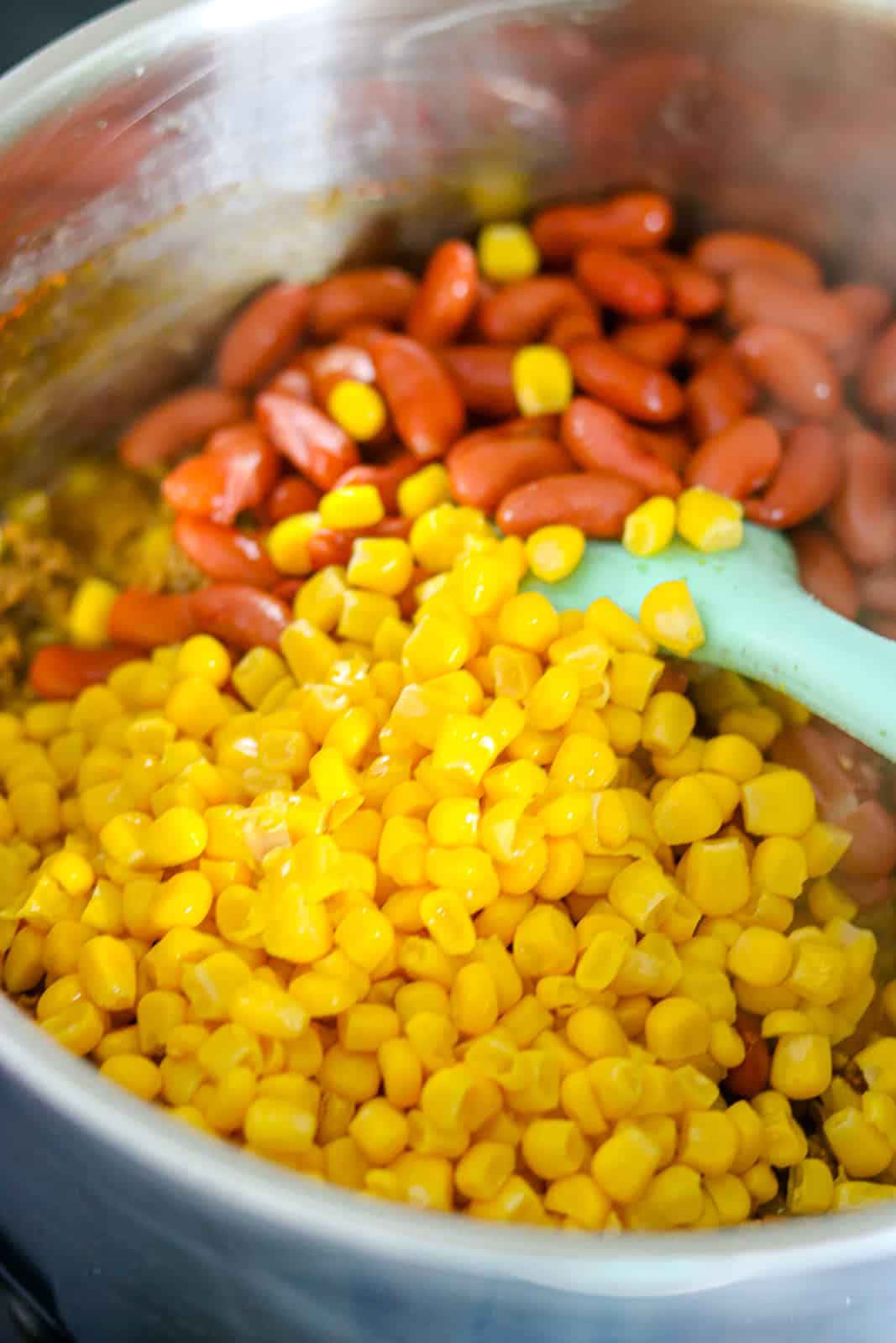 Corn and beans added in pot