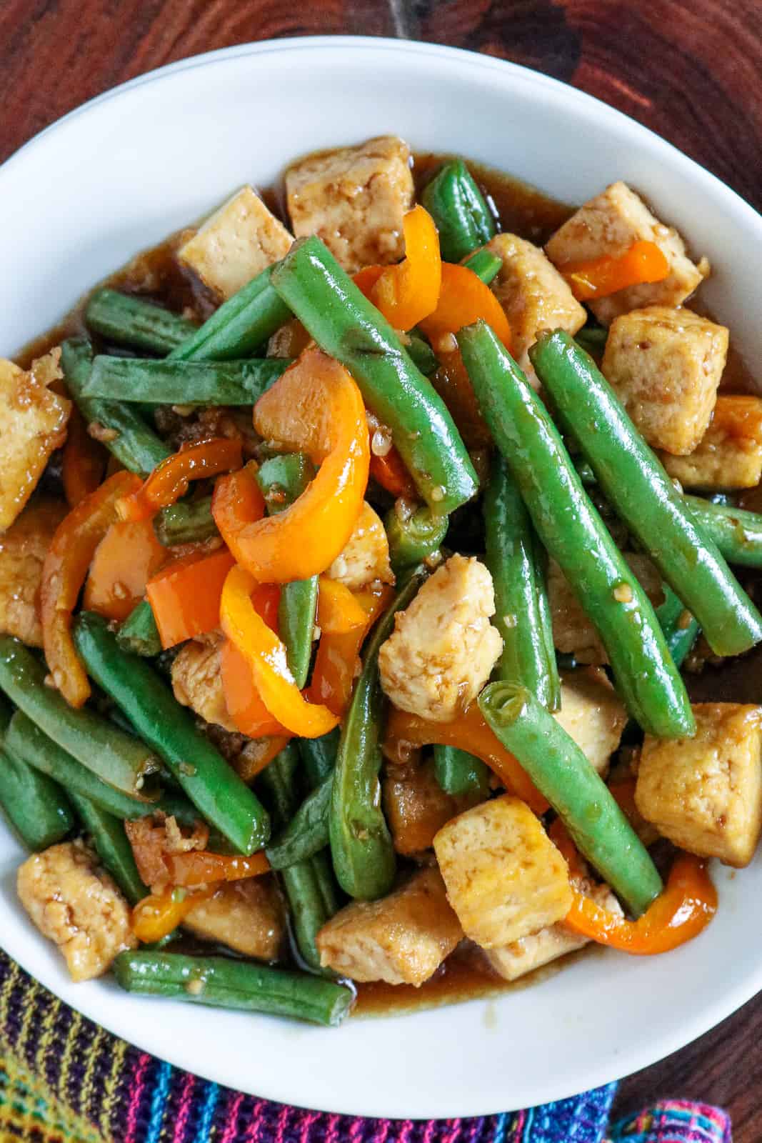 Tofu and green beans in white plate