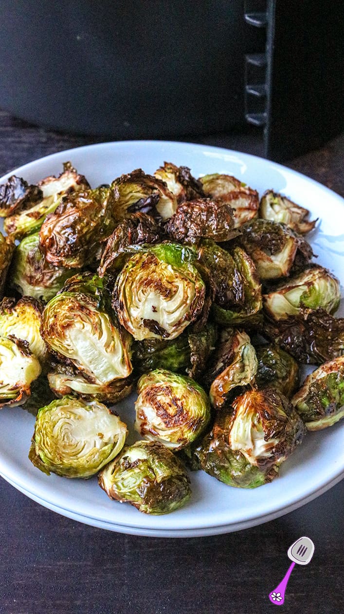 Sprouts on white plate on dark wooden table