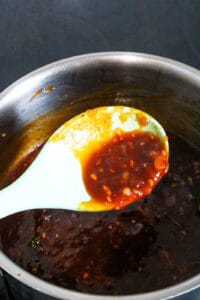 Sauce lifted with spoon from saucepan