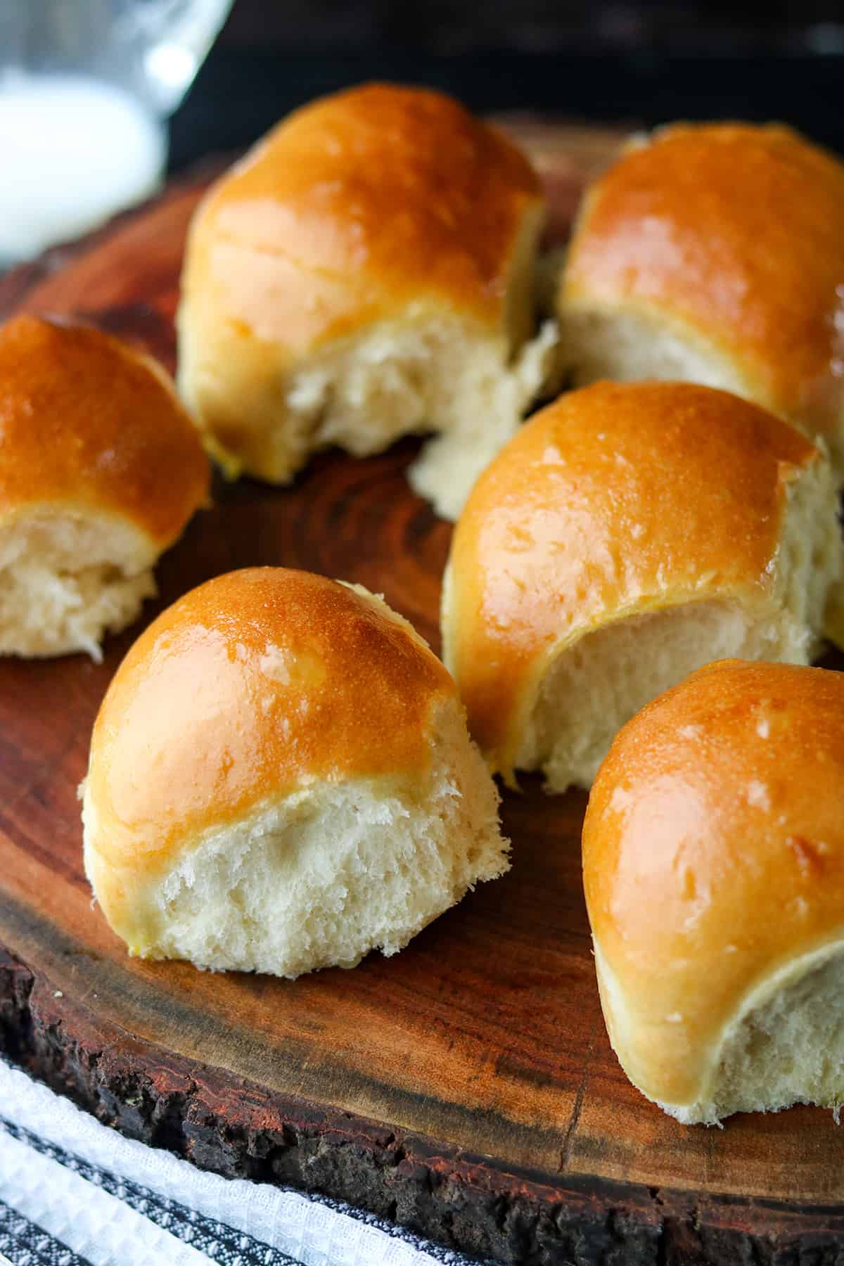 Milk bread rolls on a wooden cutting board