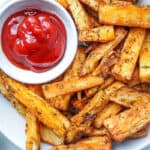 fries in the white plate with ketchup