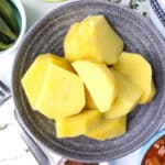 sliced cooked yams in gray bowl