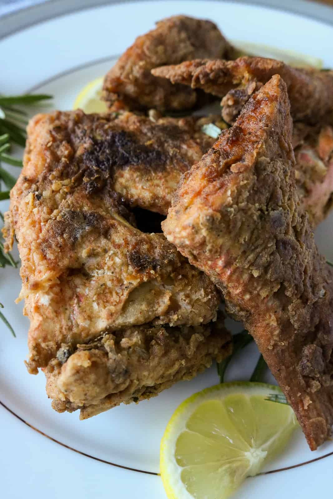 cut snapper on white plate with lemon wedge