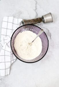flour, salt and pepper in bowl