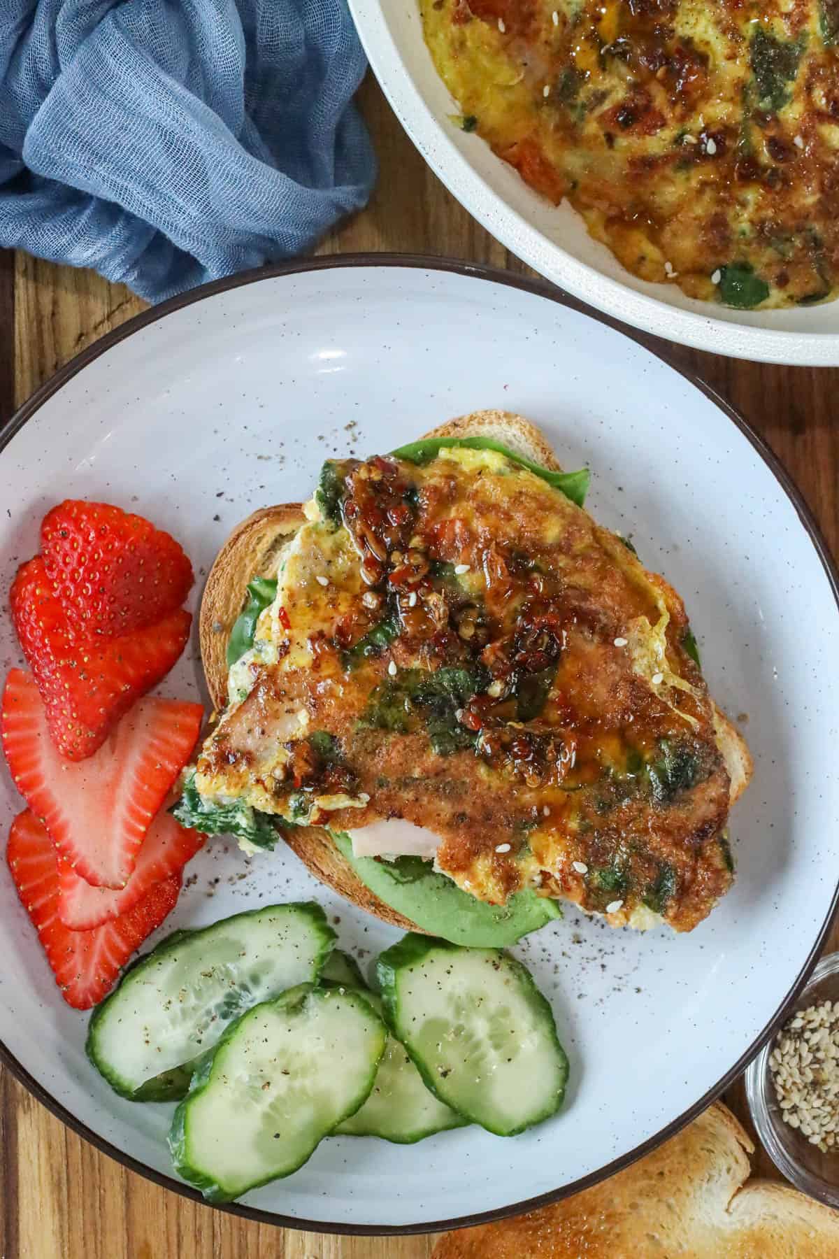 Haitian egg sandwich on toasted bread with spinach