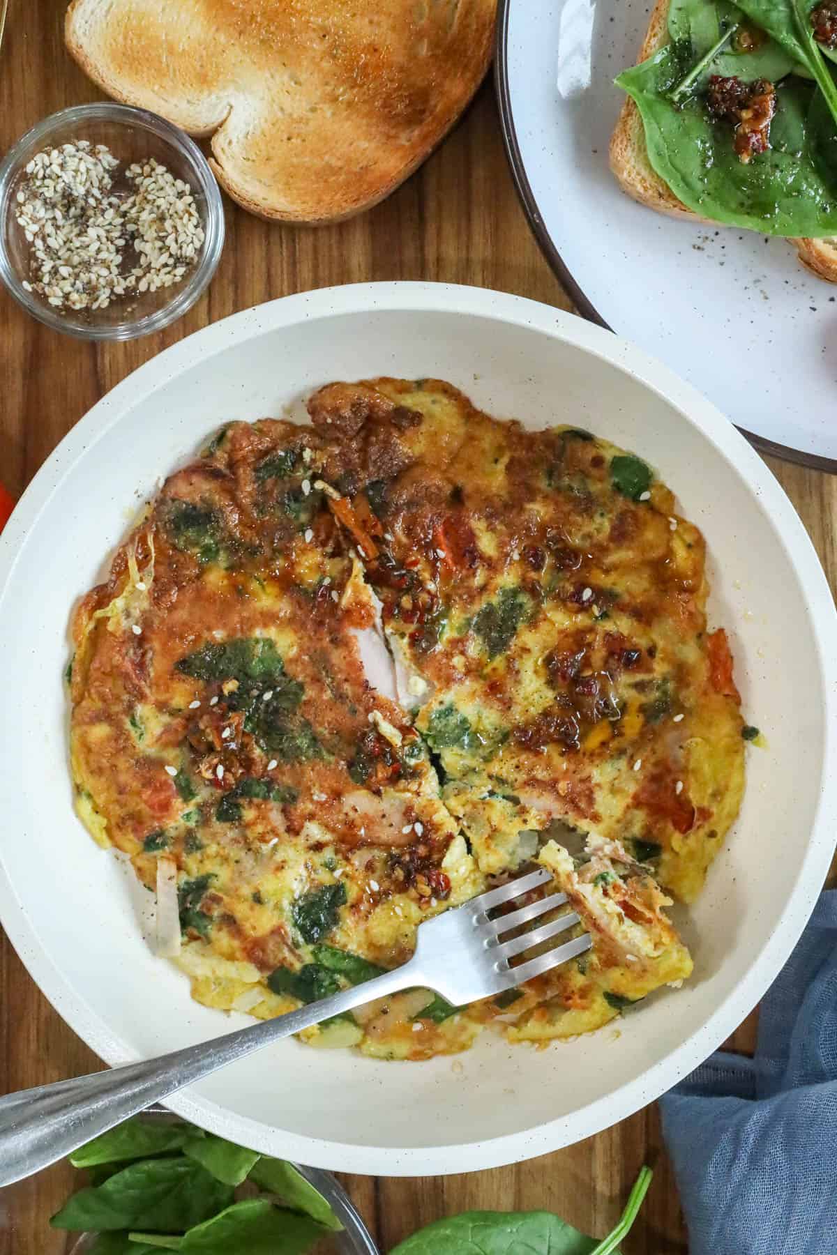 Haitian eggs with fork in pan