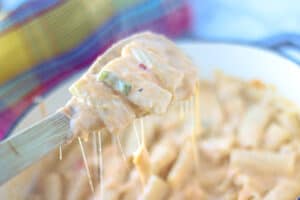 cheesy pasta on wooden spoon
