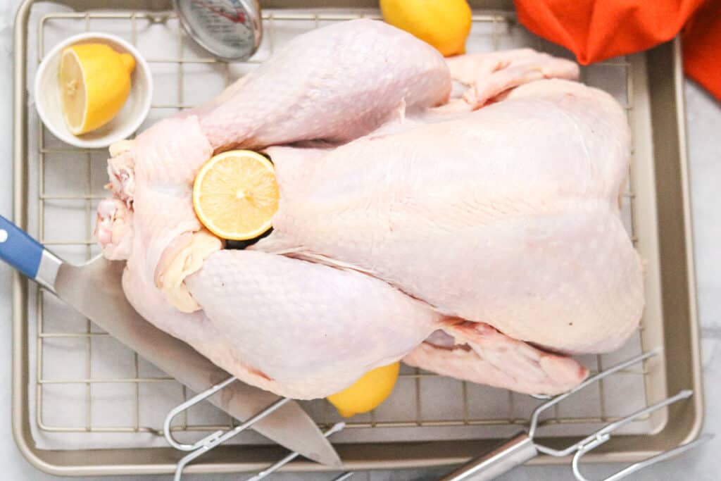 Haitian turkey - turkey on a tray with lemons and knife