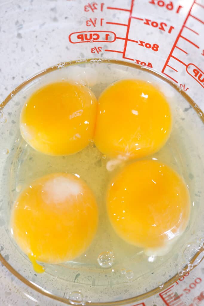 4 eggs in glass measuring cup