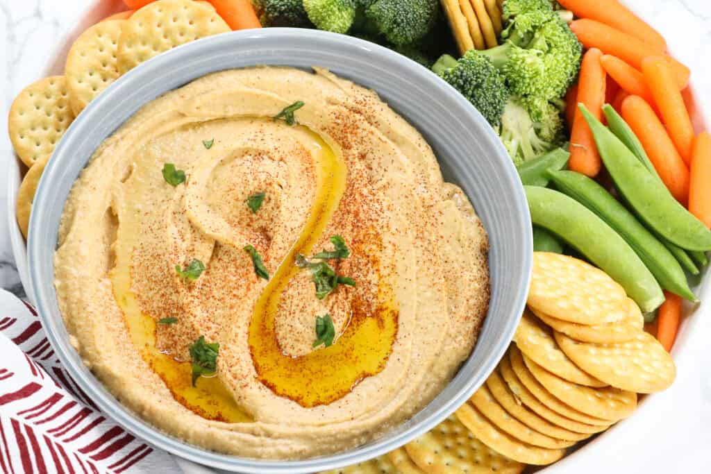 dip in gray bowl with fresh veggies and crackers