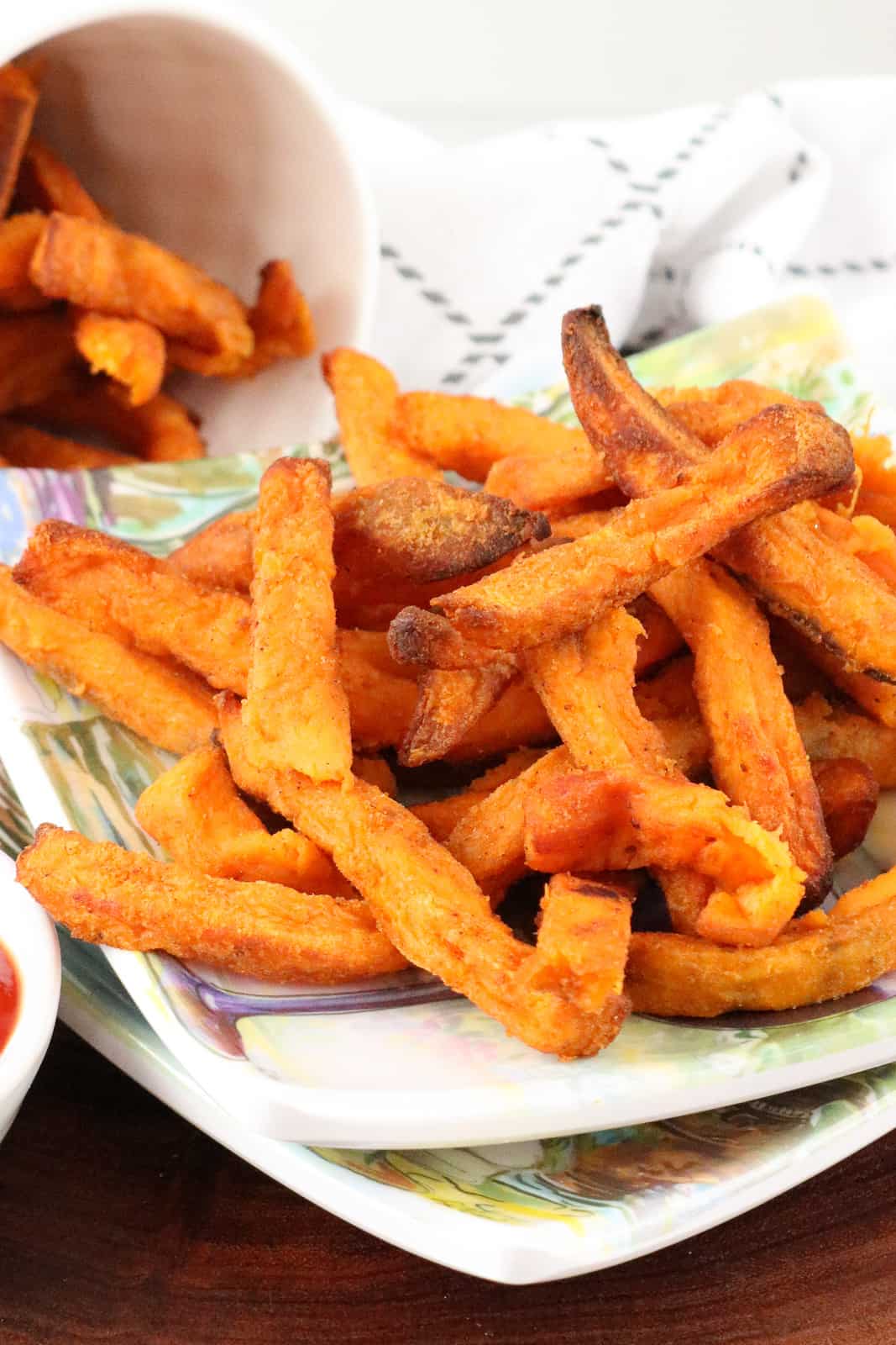 fries on plate on top of wooden board