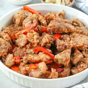 Fried Jackfruit recipe in white bowl with peppers on gray background