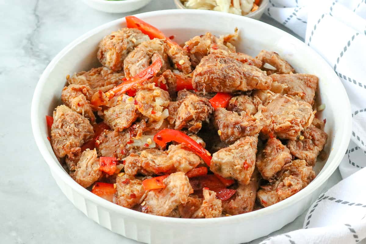 Fried Jackfruit recipe in white bowl with peppers on gray background